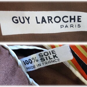 May include: A brown silk scarf with a white label that reads "GUY LAROCHE PARIS" and a smaller white label that reads "100% SOIE SILK MADE IN FRANCE".