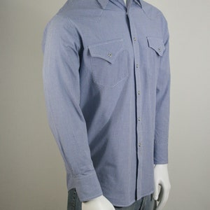 May include: A blue and white gingham long-sleeve shirt with a button-down collar and two chest pockets.