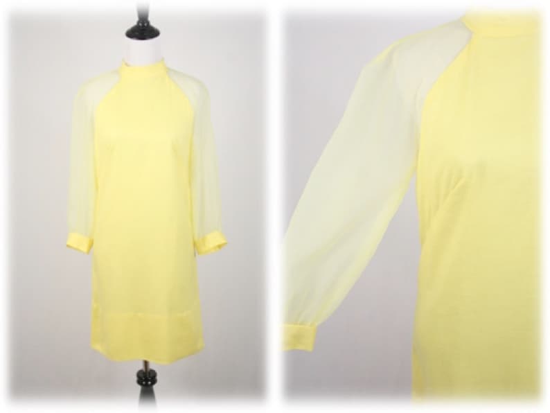 May include: A yellow dress with sheer sleeves. The dress has a high neck and a simple design.