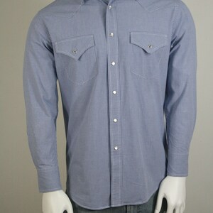 May include: A blue and white gingham long-sleeve shirt with a button-down collar and two chest pockets.