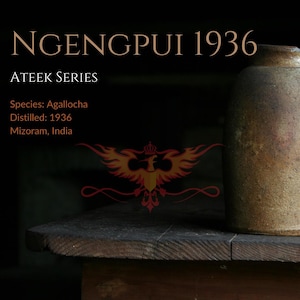 May include: A brown ceramic jar with a wide mouth, sitting on a wooden surface. The jar is labelled "NGENGPUI 1936 ATEEK SERIES" and "Species: Agallocha Distilled: 1936 Mizoram, India".