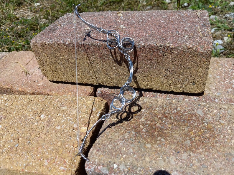 fully functional miniature hand made recycled spring-steel compound/recurve hybrid bow and arrow set. image 1