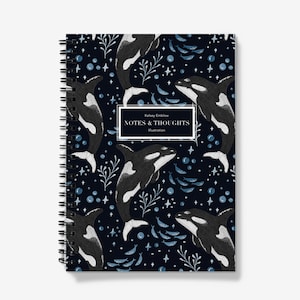 May include: A spiral-bound notebook with a dark blue cover. The cover design features black and white orcas, blue fish, and bubbles. The text "NOTES & THOUGHTS Illustration" is in a white rectangle.