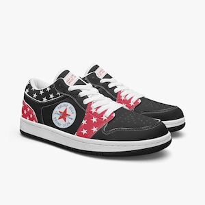 May include: Black and red low-top sneakers with a white star pattern and a red star with the text "Trump 2024" on the side. The sneakers have a white sole and a white lace.
