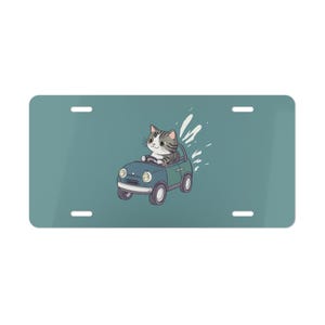 UITVERKOOP, grijze kat rijdende kaptafel blauwgroen, voorkant auto, autodecoratie, autoaccessoire, kentekenplaat
