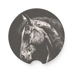 May include: A circular car coaster featuring a detailed, high-contrast black and white illustration of a horse head in profile. The design showcases the horse's mane and facial features with intricate shading against a dark, textured background.