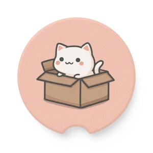 May include: A round, light pink car coaster featuring a cartoon cat in a cardboard box. The cat is white with black eyes and a small, smiling mouth. The box is brown, and the coaster has a small indentation for easy removal.