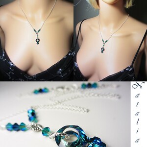 May include: A silver chain necklace with a teardrop-shaped pendant made of faceted green and blue crystals. The pendant is a stylized female symbol.