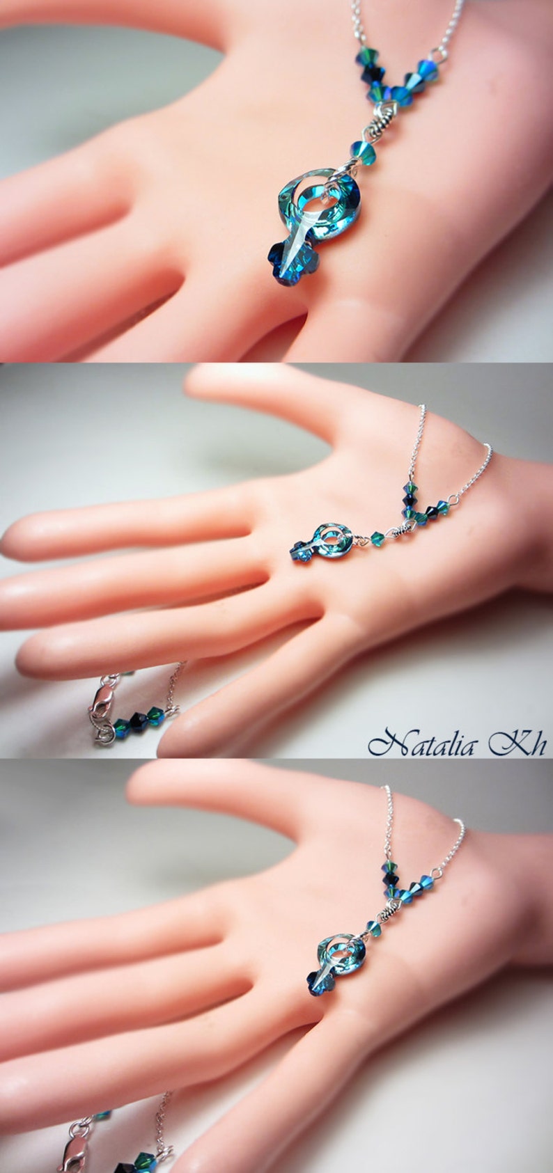 May include: A silver chain necklace with a blue crystal pendant in the shape of a treble clef. The necklace has smaller blue crystals along the chain.