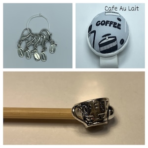 May include: A set of five silver coffee bean stitch markers with a silver ring. The stitch markers are attached to the ring with silver jump rings. The stitch markers are in the shape of coffee beans. The ring is a circle with a small gap in it. The stitch markers are a great way to mark your place in your knitting or crocheting project.