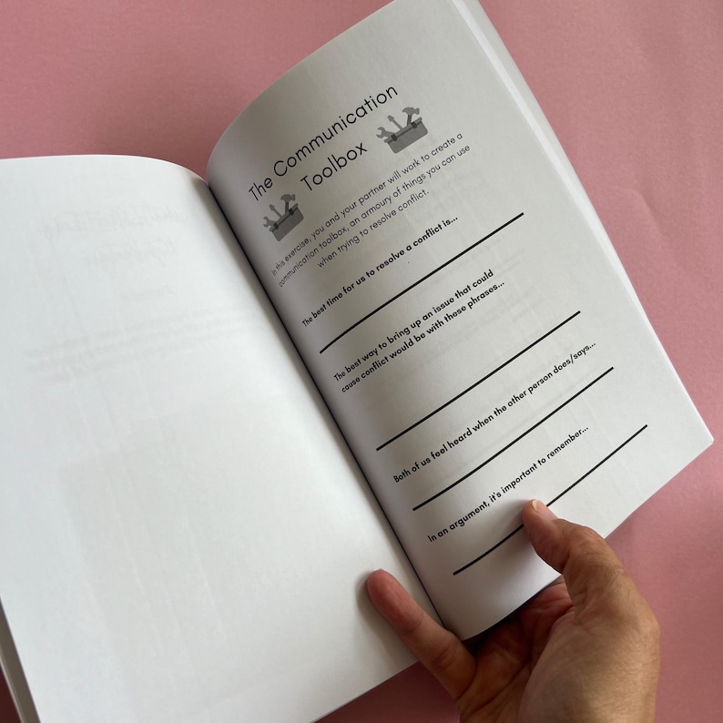 May include: An open book with a white background and black text. The book is titled "The Communication Toolbox". The text on the page includes the following: "The best time for us to resolve a conflict is...", "The best way to bring up an issue that could cause conflict would be with these phrases...", "Both of us feel heard when the other person does/says...", and "In an argument, it's important to remember...".