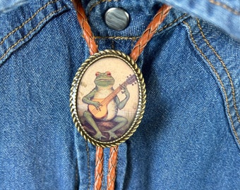 Banjo Rana Bolo Tie - Regali occidentali per lei Accessori per cravatte in pelle Collana verde Animale Musicista Musica country Rospo Divertente Cappello Bola