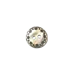 May include: A white two-hole button with a decorative floral design around the edge.