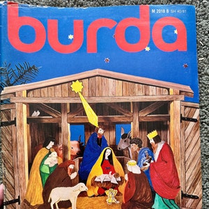May include: A vintage magazine cover featuring a Christmas nativity scene illustration. The cover is red and white with the word "burda" in large red letters. The text "Weihnachtsbasteln" is printed in black at the bottom of the cover. The magazine is from 1981 and has a price of £6.20.