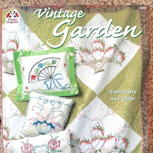 May include: A vintage-style embroidery and quilting pattern book featuring a green and white quilt with a basket of strawberries and a variety of embroidered pillows. The book cover features the title "Vintage Garden" and the number "5251".