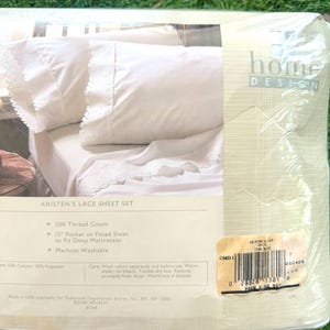 May include: A packaged white Kristen's Lace Sheet Set. The packaging shows a close-up of the sheets with lace trim. The package includes details such as 200 thread count and a 12" pocket to fit deep mattresses. The sheets are machine washable.
