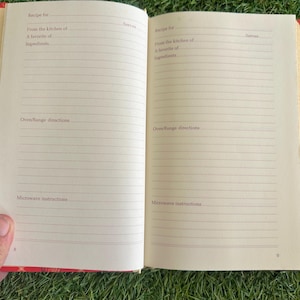 May include: Open cookbook with lined pages for recipes. The red cover has a plaid pattern. Text includes "Recipe for," "From the kitchen of," and "Oven/Range directions." The book is open to pages 8 and 9.