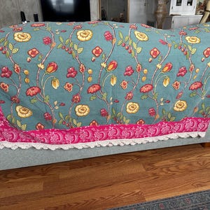 May include: A white ceramic mug with a black handle and the text "But First, Coffee" in a black, bold font. The mug is on a white surface.