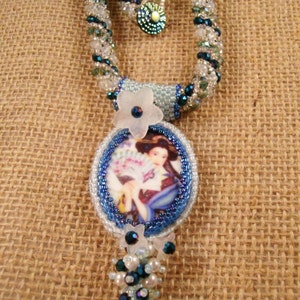 Bead embroidery and Russian Necklace- in shades of blue and white, cab of oriental woman, and a Russian spiral strap, 22 inches long.