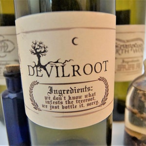 May include: A collection of glass bottles with cork stoppers and labels. The labels feature the text "DEVILROOT" and the phrase "Ingredients: we don't know what infests the treeroot, we just bottle it, sorry."
