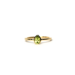 May include: A gold ring with a pear-shaped green gemstone.