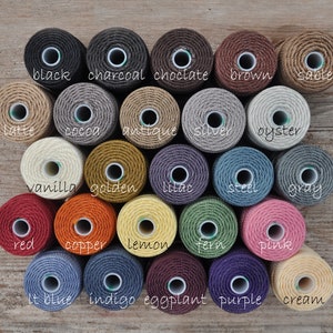 May include: A collection of 20 spools of twine in various colors, including black, charcoal, chocolate, brown, sable, latte, cocoa, antique, silver, oyster, vanilla, golden, lilac, steel, gray, red, copper, lemon, fern, pink, lt blue, indigo, eggplant, purple, and cream.
