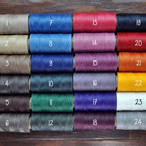 May include: Twenty-four spools of waxed thread in various colors, numbered 1 through 24.