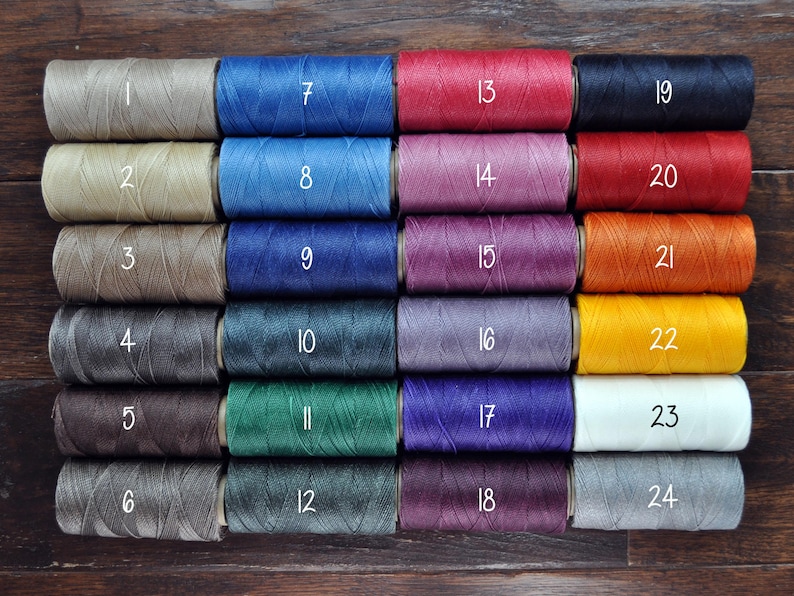 May include: Twenty-four spools of waxed thread in various colors, numbered 1 through 24.