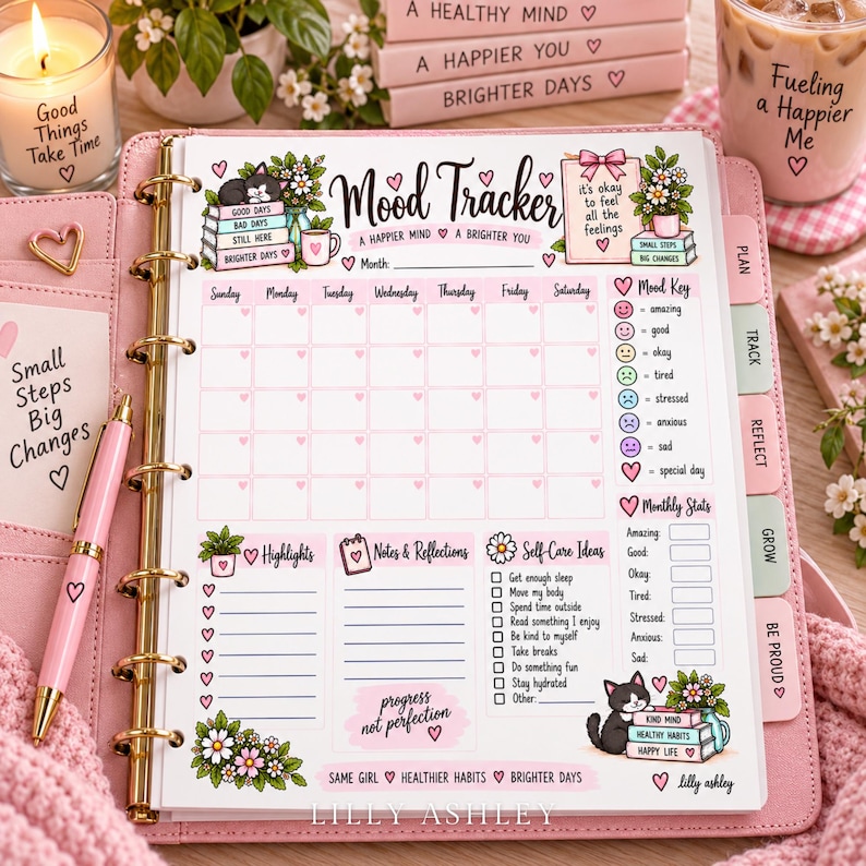 May include: A pink ring-bound planner featuring a Mood Tracker page with illustrations of cats, flowers, and hearts. The page includes sections for a monthly calendar, mood key, highlights, notes, self-care ideas, and monthly stats with text.