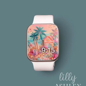 May include: A white smartwatch with a beach scene on the display. The screen shows a pink house, palm trees, and the time 9:15 AM, Sept 16. The watch has a white strap and a silver-coloured frame. The brand name "lilly ASHLEY" is displayed at the bottom.