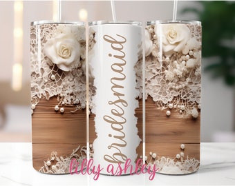 May include: White tumbler with a lace and pearl design and the word "bridesmaid" written in brown text.