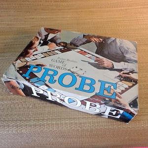 May include: Vintage Parker Brothers "Probe" board game box. The box features the game title in large blue letters, with the words "Game of Words" above. The box shows people playing the game.