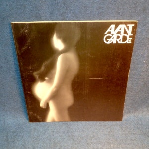 May include: A vintage magazine cover featuring a black and white photo of a pregnant woman. The magazine title is "AAN GARDE" in white letters.