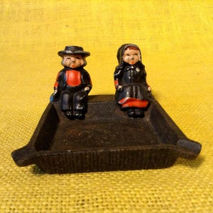 Cast Iron Ashtray With Amish Man and Woman Seated - Pennsylvania Dutch or Mennonite Couple