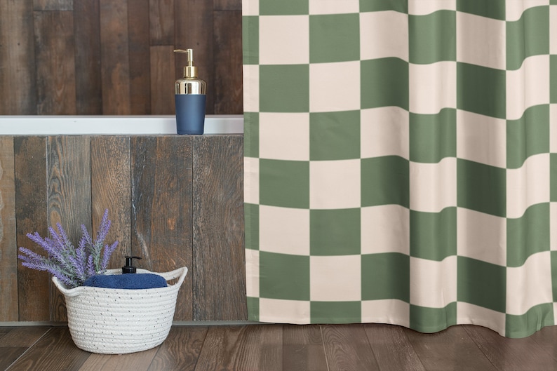 May include: A green and white checkered shower curtain hangs in a bathroom with a wooden wall and a white bathtub. A basket with lavender and a blue towel sits on the floor.
