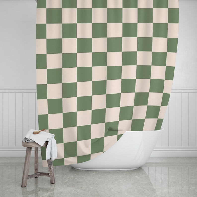 May include: A green and cream checkered shower curtain hangs in a bathroom. The curtain is made of a soft, water-resistant fabric and is perfect for adding a touch of style to any bathroom.