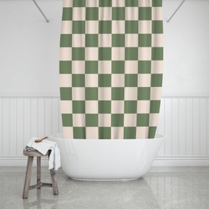 May include: A white bathtub with a green and white checkered shower curtain.