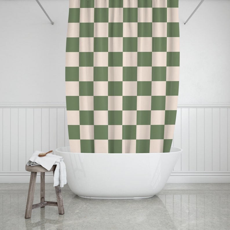 May include: A white bathtub with a green and white checkered shower curtain.