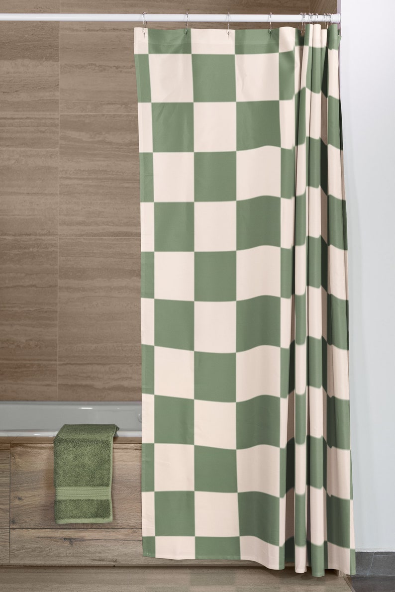 May include: A green and white checkered shower curtain with a simple design. The curtain is hung on a silver shower rod.
