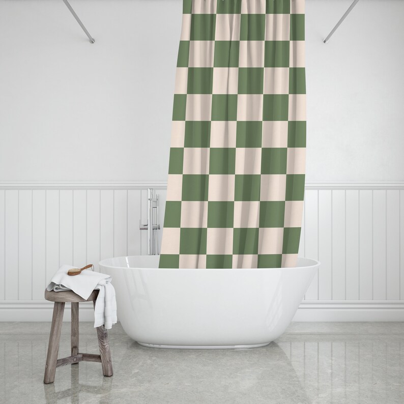 May include: A white bathtub with a green and white checkered shower curtain in a bathroom setting.