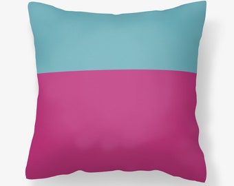 May include: A decorative pillow with a teal top half and a magenta bottom half.