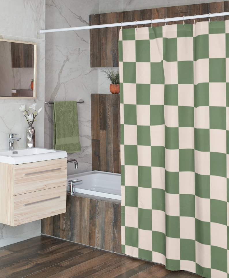 May include: A green and white checkered shower curtain hangs in a bathroom with a white bathtub and wood-look tile.