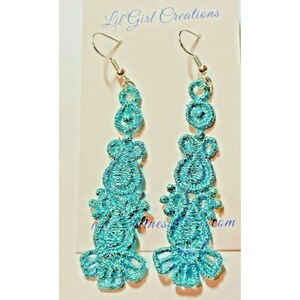 May include: A pair of turquoise blue dangle earrings with a delicate lace design. The earrings are made of silver and have a hook closure.