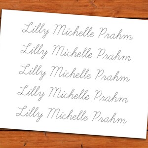 May include: Five lines of cursive handwriting on a white sheet of paper. The name "Lilly Michelle Prahm" is written in cursive on each line.