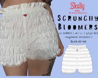 May include: White scrunchy bloomers with a ruffled waist and hem, featuring a small red heart detail. The image includes a sewing pattern with the text "SCRUNCHY BLOOMERS" and "SIZES XS-XXL".