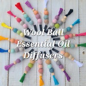 May include: A white ceramic mug with a black handle and the text "But first, coffee" in a black, handwritten-style font. The mug is on a white surface.