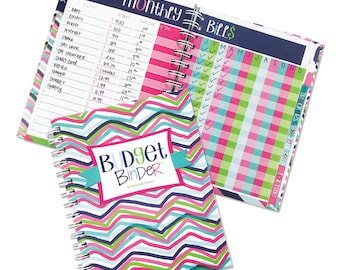 May include: A pink, green, and blue budget binder with a zig-zag pattern and the text "Budget Binder" on the front cover.