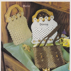 May include: Three macrame bags with wooden handles. The bags are made with a knotting technique and are in beige, white, and brown colors. The bags are labeled "Marie", "Donna", and are on a wooden surface.