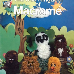 May include: A craft book titled "The Wild Kingdom of Macrame" featuring a lion, panda, chick, and bear made from yarn. The book cover is blue with green leaves and a brown tree trunk.