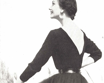 May include: A black dress with a low back and a full skirt. The dress has a belt at the waist and the model is wearing large hoop earrings.